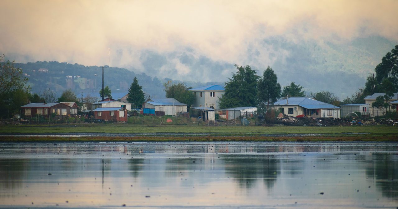 View of houses at the waterfront of the Chamiza marine wetland in Chile